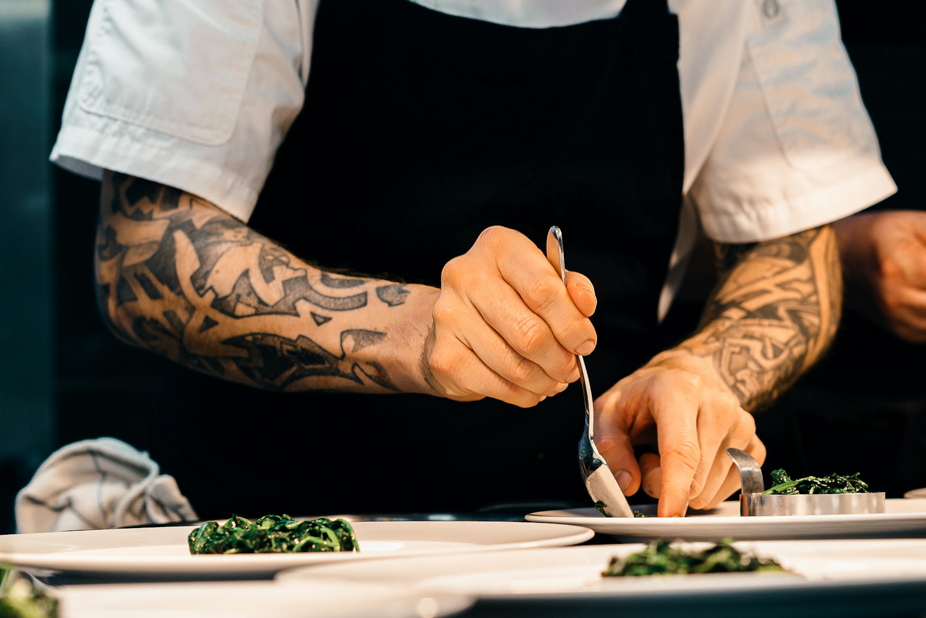 Chef plating a dish in a professional kitchen